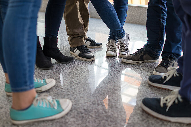 Young people legs standing in circle