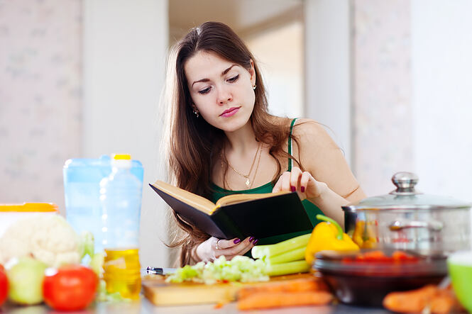 Thoughtful,Girl,Cooking,With,Cookbook,In,The,Kitchen,At,Home